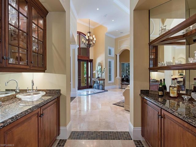a dining room with furniture a chandelier and window