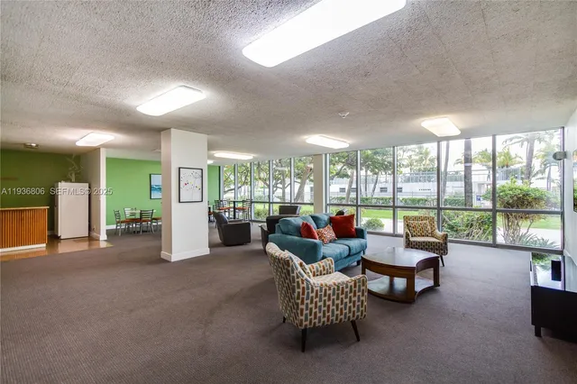 a living room with furniture and a floor to ceiling window