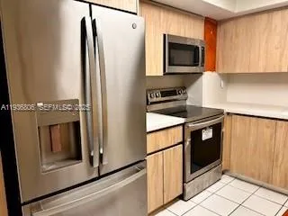 a kitchen with a stove microwave and fridge