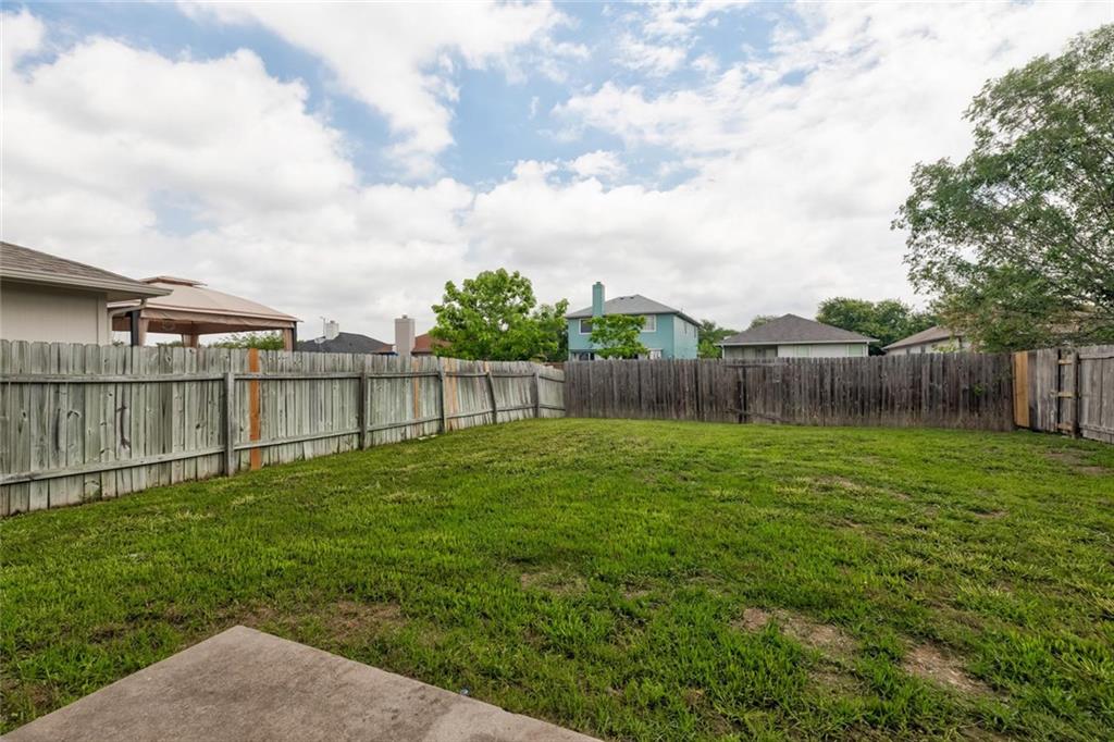 16712 Hamilton Point Circle Manor, TX 78653 - Photo 31 of 38 An expansive grassy yard is completely enclosed by a privacy fence under open skies.