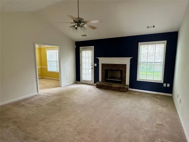 a view of empty room with a fireplace