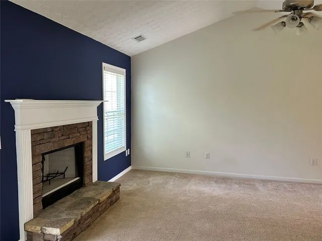 a kitchen with granite countertop a stove and a refrigerator