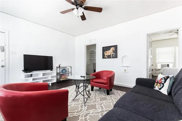 a living room with furniture and a flat screen tv