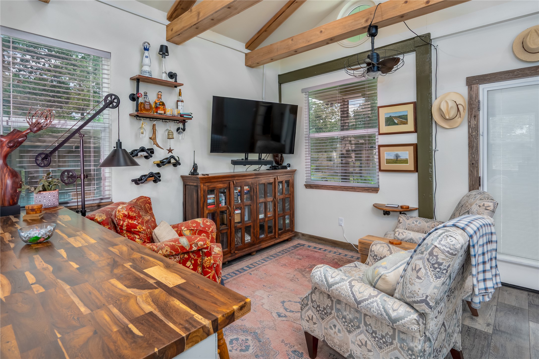 270 Dry Creek Road Manor, TX 78653 - Photo 32 of 40 Exposed beams complement a cheerful interior with ample window views and inviting seating.