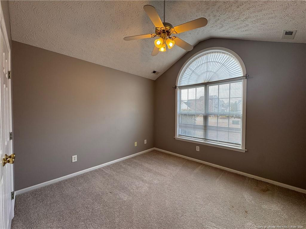 5503 Rising Ridge Drive Hope Mills, NC 28348 - Photo 12 of 18 an empty room with windows and chandelier fan