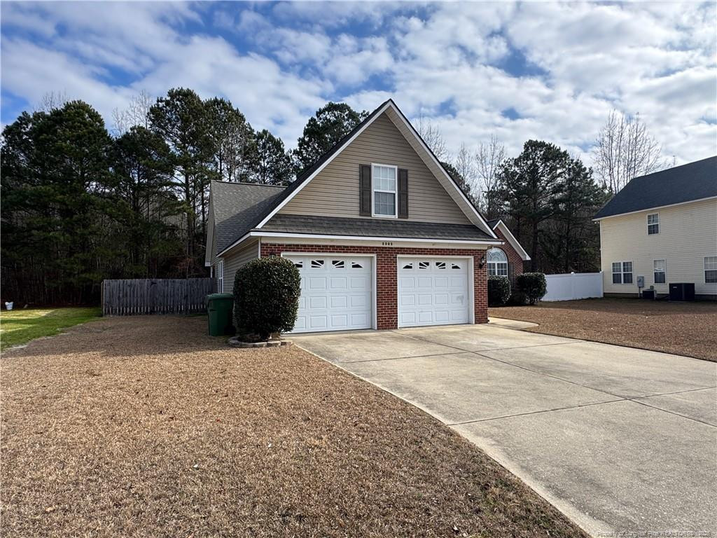 5503 Rising Ridge Drive Hope Mills, NC 28348 - Photo 3 of 18 a front view of a house with a yard and garage