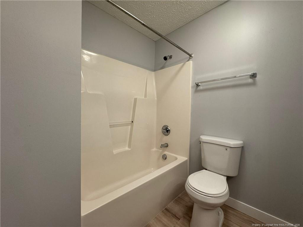 5503 Rising Ridge Drive Hope Mills, NC 28348 - Photo 10 of 18 a bathroom with a toilet and a bathtub