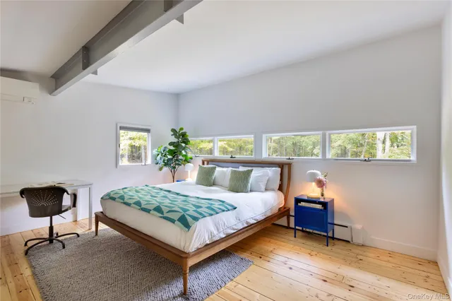 a bedroom with a bed and a potted plant