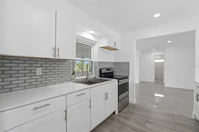 a bathroom with a shower sink and mirror