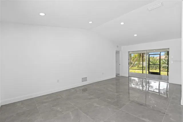 an empty room with sliding glass door and shower