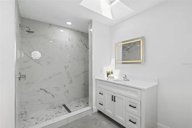 a front view of house with yard and trees in the background