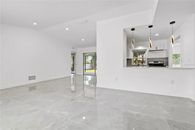 an empty room with large windows