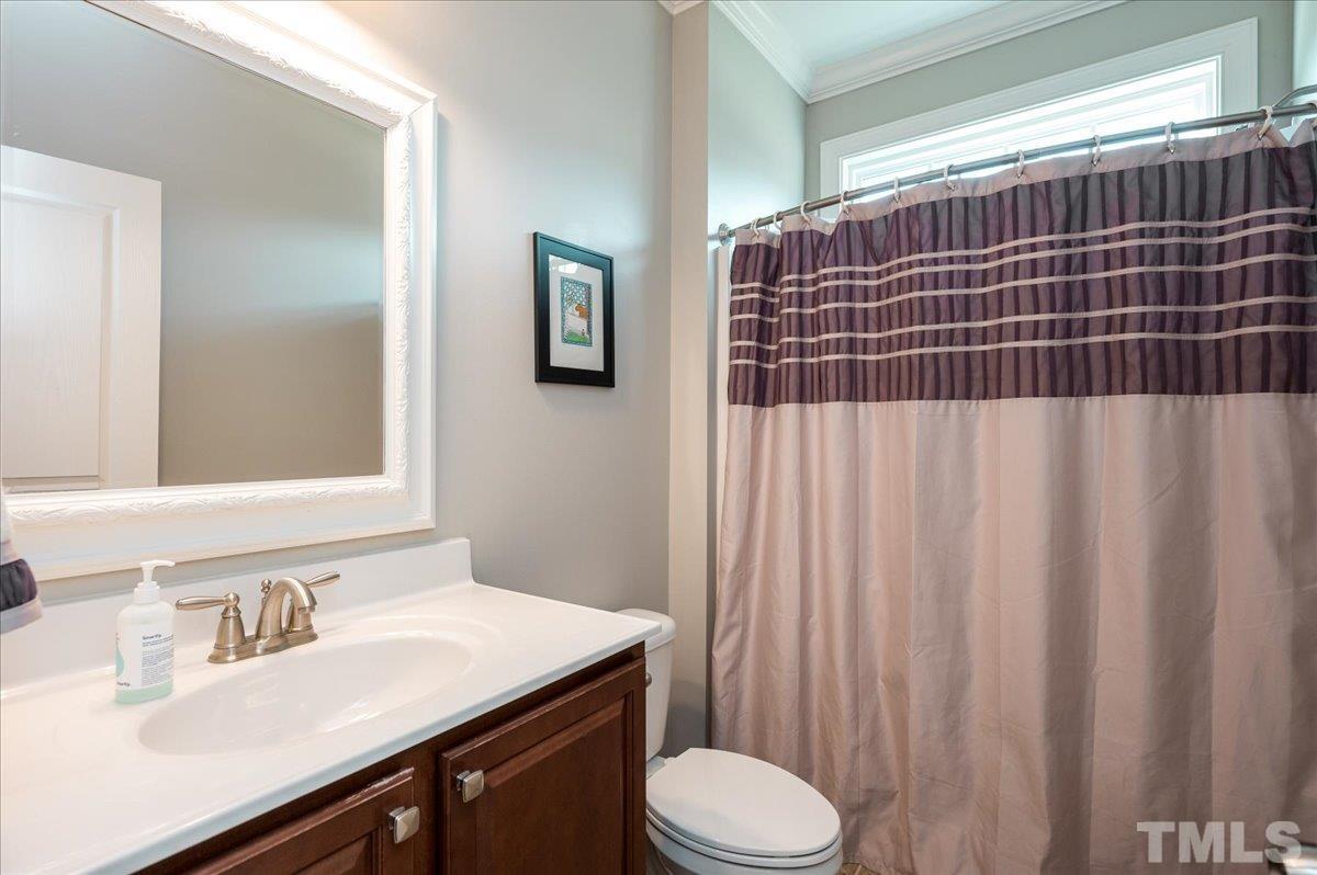 1208 Formal Garden Way Raleigh, NC 27603 - Photo 22 of 33 a bathroom with a sink a toilet and shower