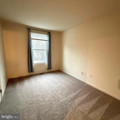 a view of an empty room and a window