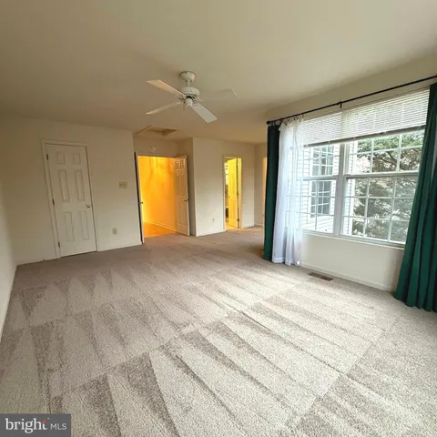 an empty room with windows and closet