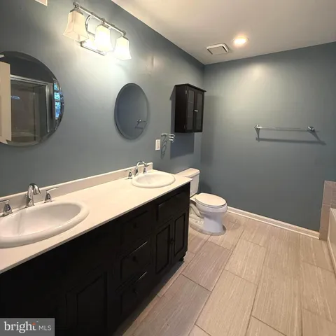 a white bath tub sitting next to a shower
