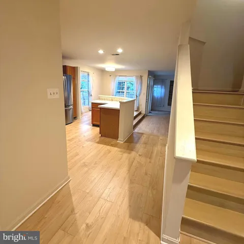 a kitchen with granite countertop a refrigerator and a stove top oven