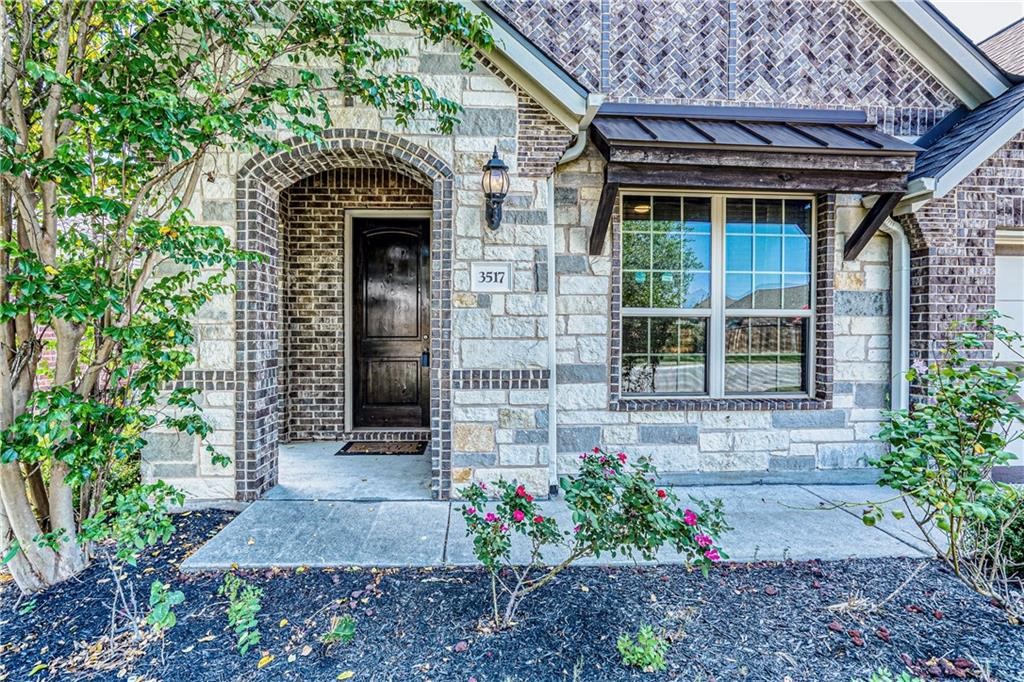 3517 Grail Hollows Road Pflugerville, TX 78660 - Photo 3 of 40 a front view of a house with a garden