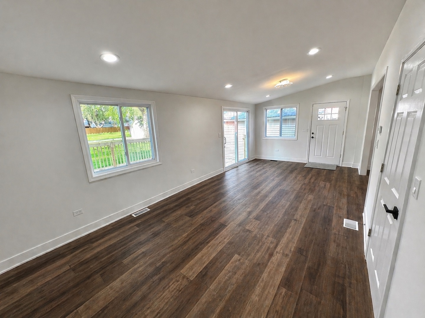 126 Prairie Street Ottawa, IL 61350 - Photo 5 of 15 an empty room with wooden floor and windows