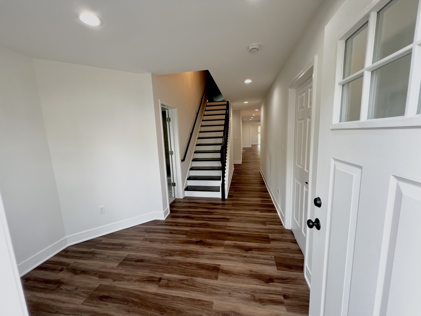 126 Prairie Street Ottawa, IL 61350 - Photo 6 of 15 a view of a hallway with wooden floor and staircase