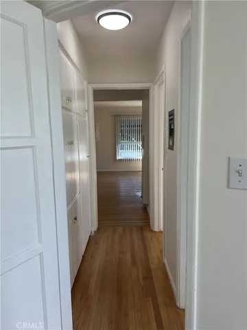 a view of a hallway with wooden floor
