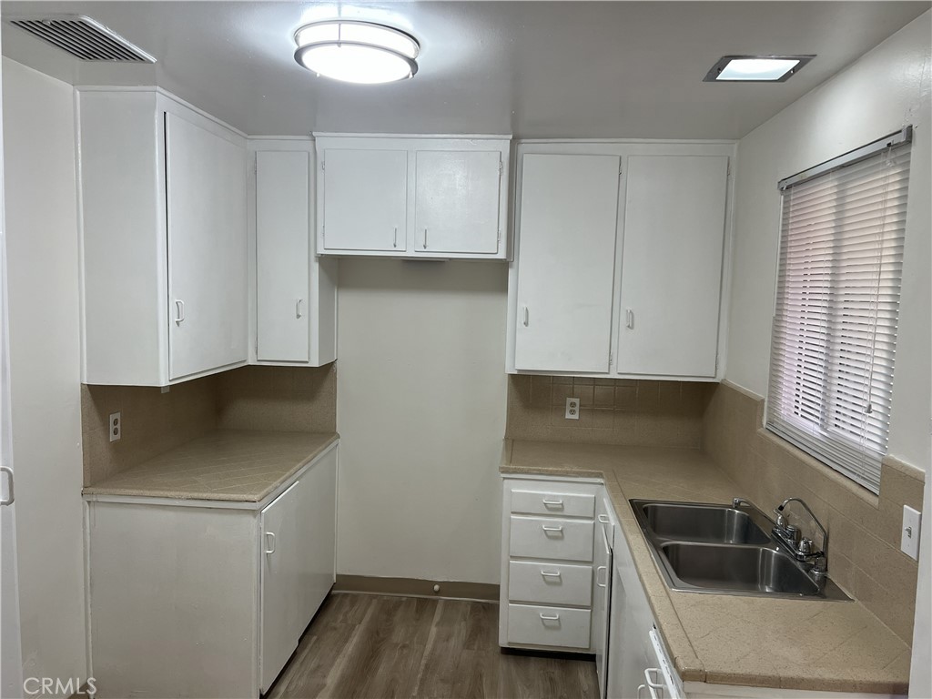 401 West Grand Avenue, Unit C Alhambra, CA 91801 - Photo 14 of 14 a kitchen with a sink stove and cabinets