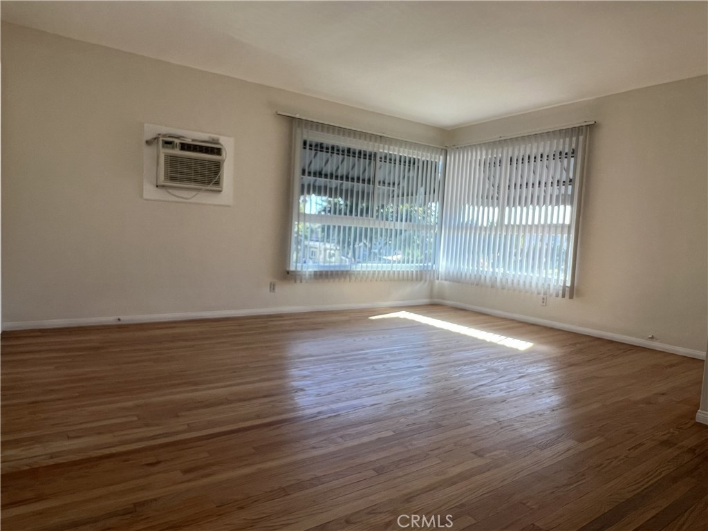 401 West Grand Avenue, Unit C Alhambra, CA 91801 - Photo 5 of 14 a view of an empty room with wooden floor and a window