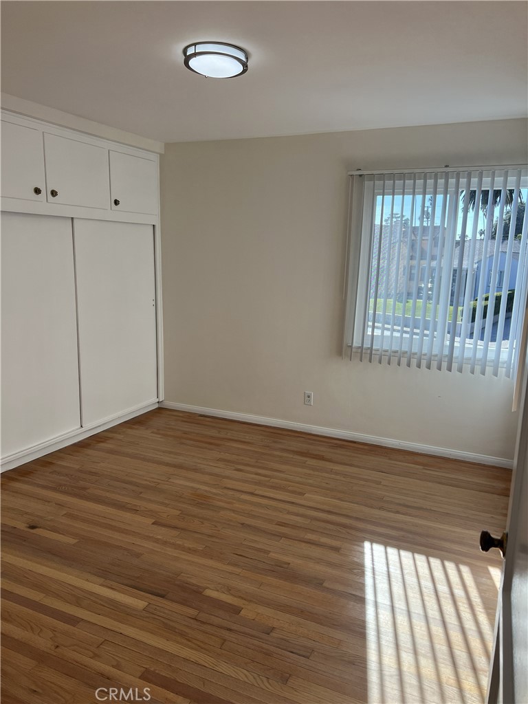 401 West Grand Avenue, Unit C Alhambra, CA 91801 - Photo 7 of 14 wooden floor in an empty room with a window