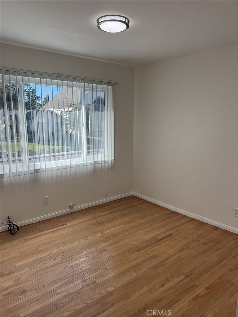 401 West Grand Avenue, Unit C Alhambra, CA 91801 - Photo 9 of 14 an empty room with wooden floor and windows