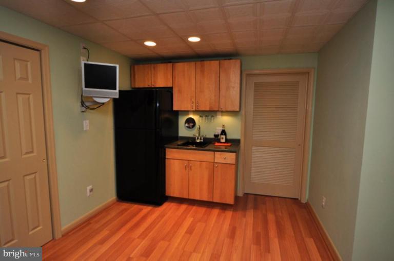 11322 Dockside Circle Reston, VA 20191 - Photo 12 of 22 a kitchen with stainless steel appliances granite countertop a refrigerator and a stove top oven