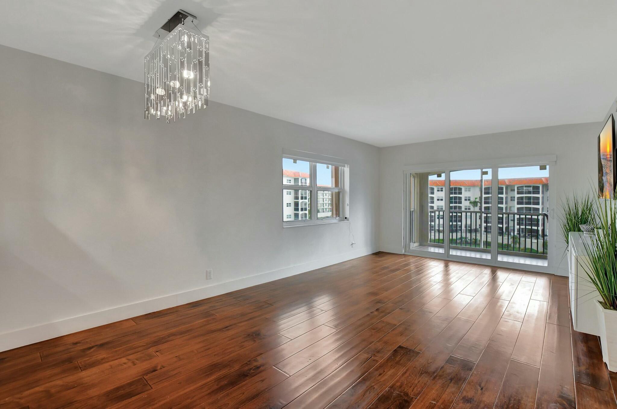 2871 North Ocean Boulevard, Unit V441 Boca Raton, FL 33431 - Photo 8 of 75 a view of an empty room with wooden floor and a window