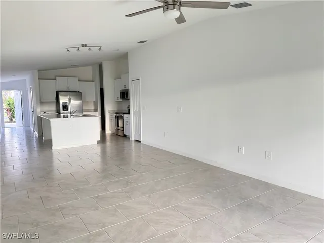 a view of a living room a refrigerator and a stove