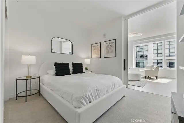 a bedroom with a bed and a lamp