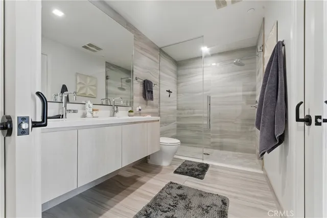 a bathroom with a sink a toilet and shower