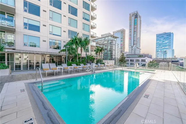 a view of a swimming pool with outdoor seating