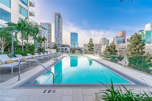 a swimming pool with outdoor seating and yard