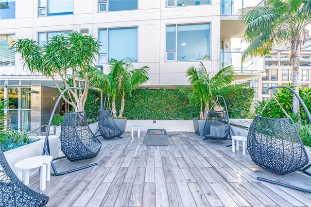 a view of a patio with a table and chairs and potted plants