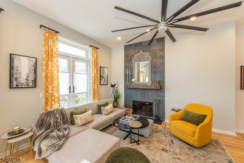 523 Trinity Place Westfield, NJ 07090 - Photo 11 of 33 a living room with furniture a fireplace and a flat screen tv