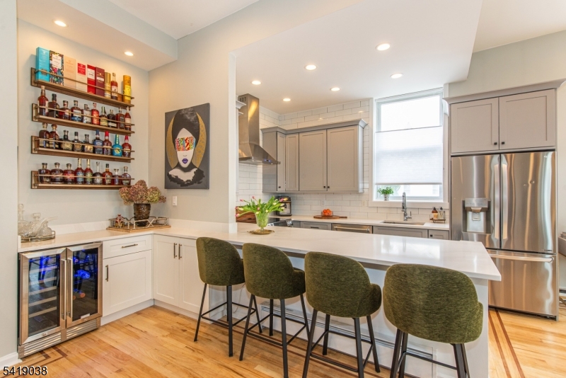 523 Trinity Place Westfield, NJ 07090 - Photo 15 of 33 a kitchen with stainless steel appliances granite countertop a table chairs sink and cabinets