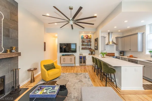 a living room with furniture kitchen view and a flat screen tv