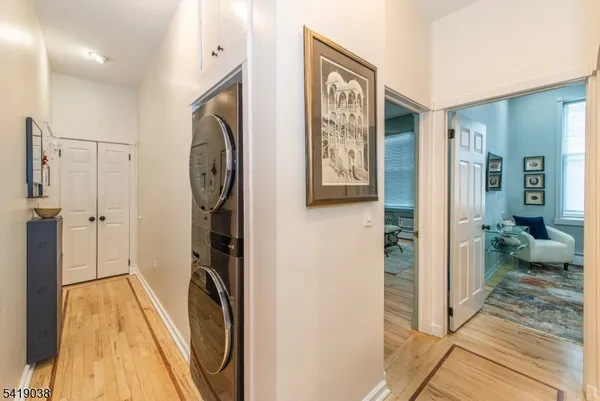 a kitchen with stainless steel appliances granite countertop a refrigerator and a dining table