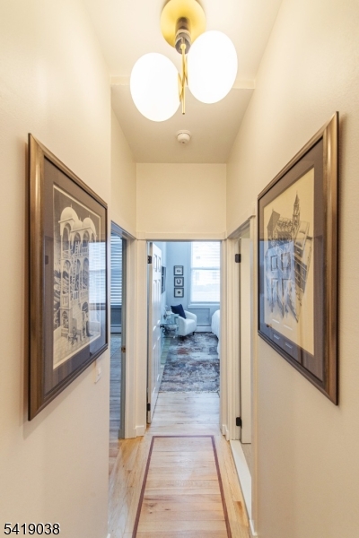 523 Trinity Place Westfield, NJ 07090 - Photo 9 of 33 a view of a hallway with paintings on the wall
