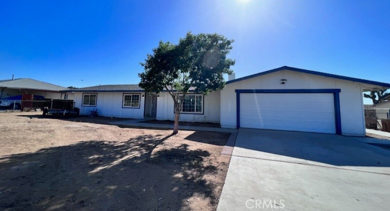 11970 Pasco Road Apple Valley, CA 92308 - Photo 1 of 1 a front view of a house with a yard and garage