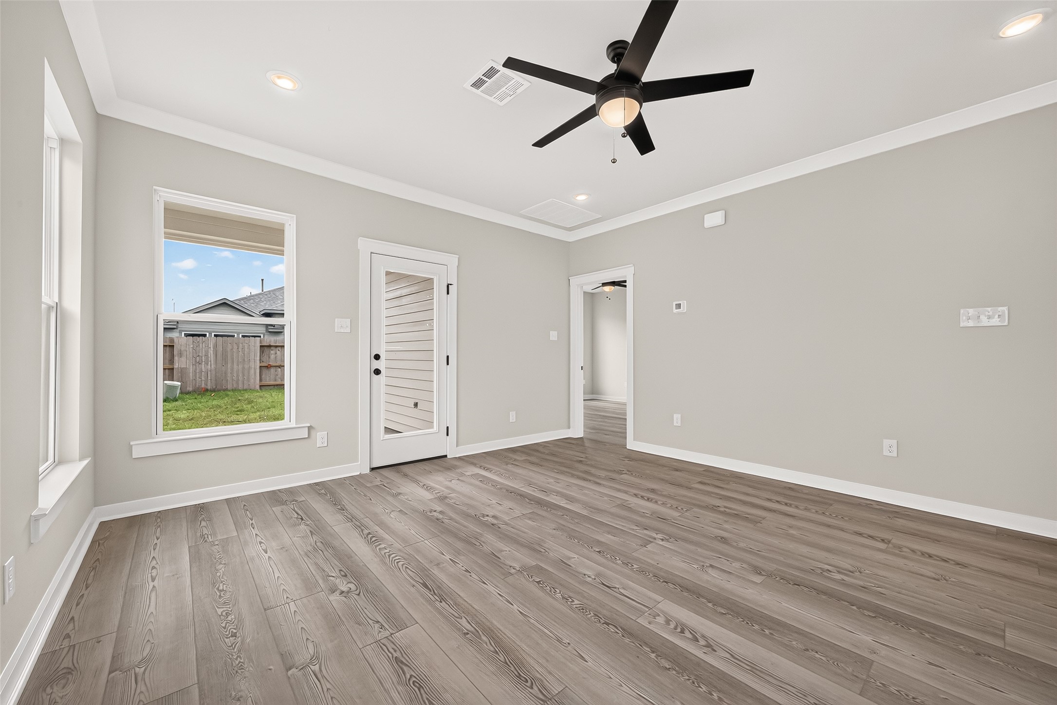 21122 Autumn Heights Rosharon, TX 77583 - Photo 9 of 42 an empty room with wooden floor fan and windows