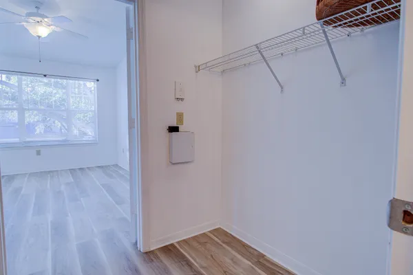 a view of a room with wooden floor and cabinet