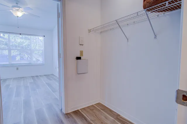 a view of a room with wooden floor and cabinet