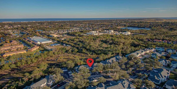 an aerial view of a houses with a yard