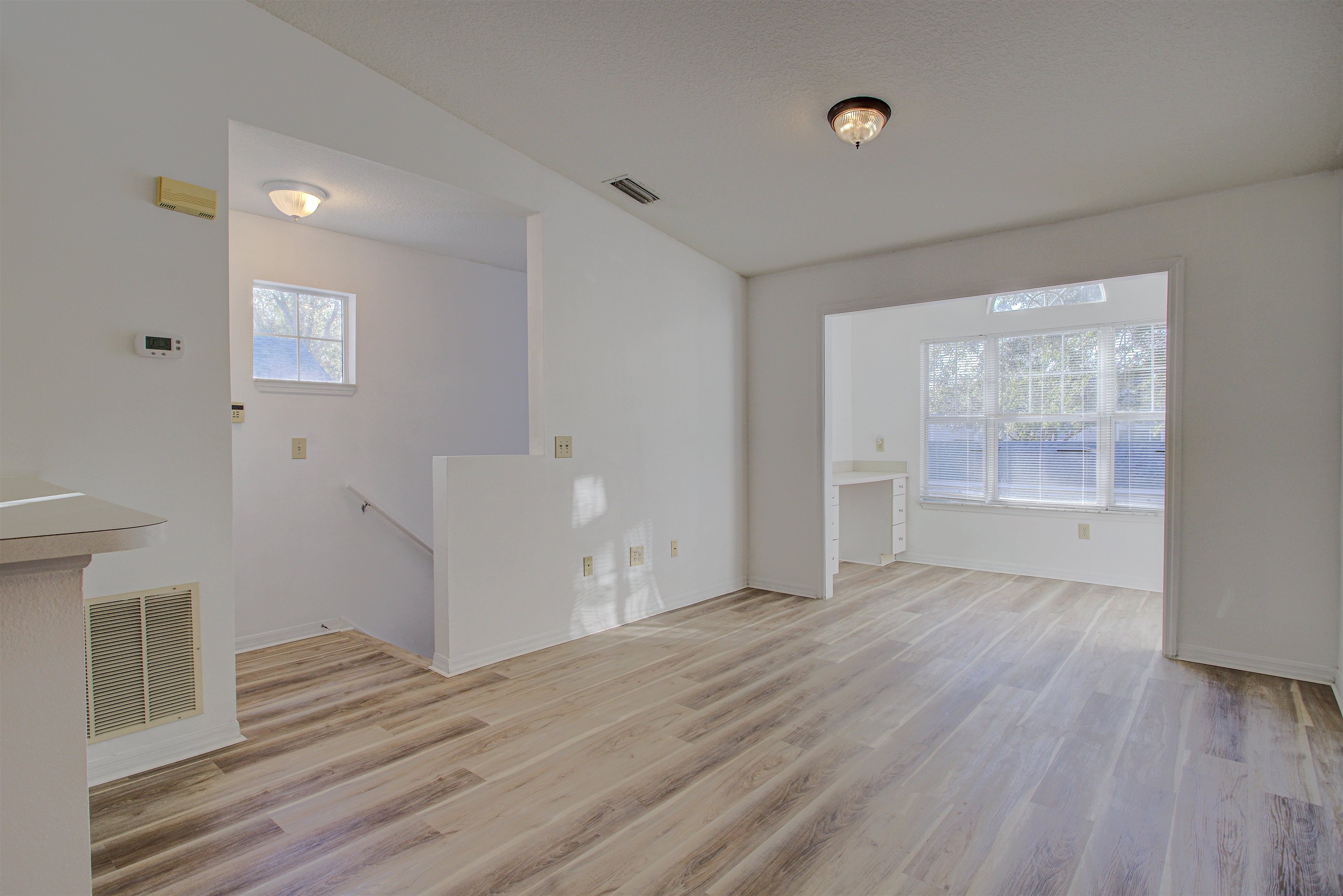 15205 Harbour Vista Circle St. Augustine, FL 32080 - Photo 2 of 20 a view of an empty room with wooden floor and a window