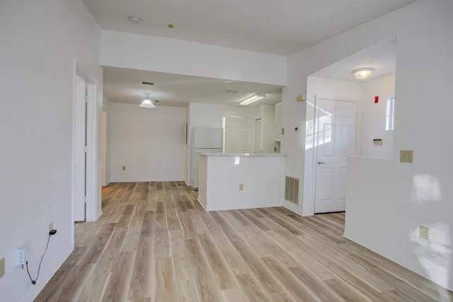 a view of a room with wooden floor and a sink