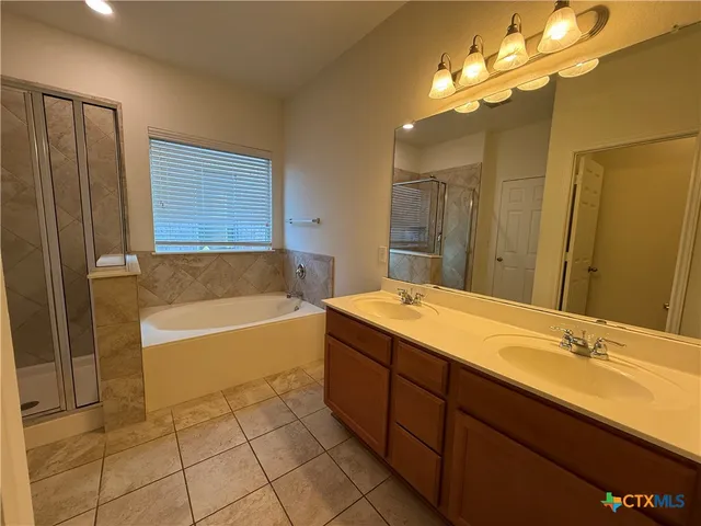 a bathroom with a tub sink and a mirror